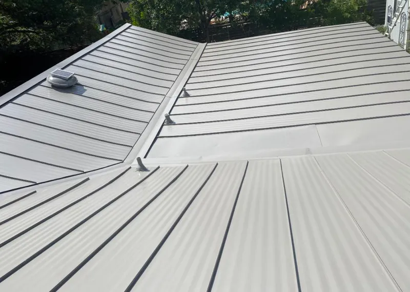 Solar attic fan installed on a metal roof for Roof Ventilation in Ranson corporation